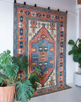 Vintage caucasian rug in a living room setting, pile rug, Turkish rug, vintage rug, portland, rug shop, bright colors, wild shaman, soft rug, bold color, Portland, Oregon, rug store, rug shop, local shop, soft rug, pastel colors, faded colors