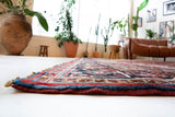 Antique Persian area rug in a living room setting, pile rug, vintage rug, portland, rug shop, bright colors, wild shaman, soft rug, bold color, Portland, Oregon, rug store, rug shop, local shop, antique rug, Persian rug, handmade rug, wool rug