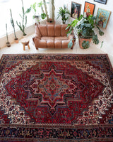 Antique Persian area rug in a living room setting, pile rug, vintage rug, portland, rug shop, bright colors, wild shaman, soft rug, bold color, Portland, Oregon, rug store, rug shop, local shop, antique rug, Persian rug, handmade rug, wool rug