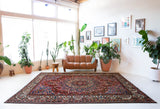 Antique Persian area rug in a living room setting, pile rug, vintage rug, portland, rug shop, bright colors, wild shaman, soft rug, bold color, Portland, Oregon, rug store, rug shop, local shop, antique rug, Persian rug, handmade rug, wool rug