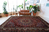 Antique Persian area rug in a living room setting, pile rug, vintage rug, portland, rug shop, bright colors, wild shaman, soft rug, bold color, Portland, Oregon, rug store, rug shop, local shop, antique rug, Persian rug, handmade rug, wool rug