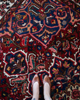 Antique Persian area rug in a living room setting, pile rug, vintage rug, portland, rug shop, bright colors, wild shaman, soft rug, bold color, Portland, Oregon, rug store, rug shop, local shop, antique rug, Persian rug, handmade rug, wool rug