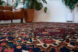 Antique Persian area rug in a living room setting, pile rug, vintage rug, portland, rug shop, bright colors, wild shaman, soft rug, bold color, Portland, Oregon, rug store, rug shop, local shop, antique rug, Persian rug, handmade rug, wool rug
