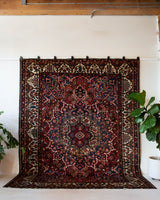 Antique Persian area rug in a living room setting, pile rug, vintage rug, portland, rug shop, bright colors, wild shaman, soft rug, bold color, Portland, Oregon, rug store, rug shop, local shop, antique rug, Persian rug, handmade rug, wool rug