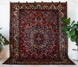 Antique Persian area rug in a living room setting, pile rug, vintage rug, portland, rug shop, bright colors, wild shaman, soft rug, bold color, Portland, Oregon, rug store, rug shop, local shop, antique rug, Persian rug, handmade rug, wool rug