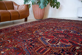 Antique Persian area rug in a living room setting, pile rug, vintage rug, portland, rug shop, bright colors, wild shaman, soft rug, bold color, Portland, Oregon, rug store, rug shop, local shop, antique rug, Persian rug, handmade rug, wool rug