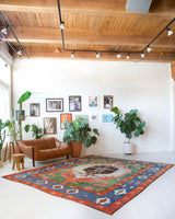 Vintage Turkish rug in a living room setting, pile rug, Turkish rug, vintage rug, portland, rug shop, bright colors, wild shaman, soft rug, bold color, Portland, Oregon, rug store, rug shop, local shop