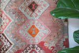 Vintage kilim rug in room decor setting, old rug, antique rug, pastel colors, faded colors, Turkish rug, vintage rug, soft rug, Portland, Oregon, rug store, rug shop, local shop, bold colors, bright colors
