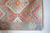 Vintage kilim rug in room decor setting, old rug, antique rug, pastel colors, faded colors, Turkish rug, vintage rug, soft rug, Portland, Oregon, rug store, rug shop, local shop, bold colors, bright colors