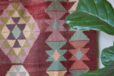 Vintage kilim rug in room decor setting, old rug, antique rug, pastel colors, faded colors, Turkish rug, vintage rug, soft rug, Portland, Oregon, rug store, rug shop, local shop, bold colors, bright colors