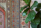 Vintage Turkish rug in living room setting, old rug, antique rug, pastel colors, faded colors, Turkish rug, vintage rug, soft rug, Portland, Oregon, rug store, rug shop, local shop