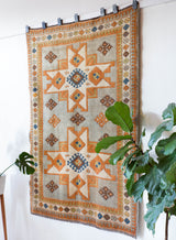 Vintage caucasian rug in a living room setting, pastel colors, faded colors, Turkish rug, vintage rug, soft rug, Portland, Oregon, rug store, rug shop, local shop