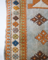 Vintage caucasian rug in a living room setting, pastel colors, faded colors, Turkish rug, vintage rug, soft rug, Portland, Oregon, rug store, rug shop, local shop