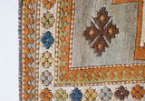 Vintage caucasian rug in a living room setting, pastel colors, faded colors, Turkish rug, vintage rug, soft rug, Portland, Oregon, rug store, rug shop, local shop