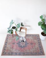 Vintage Turkish rug in living room setting, old rug, antique rug, pastel colors, faded colors, Turkish rug, vintage rug, soft rug, Portland, Oregon, rug store, rug shop, local shop