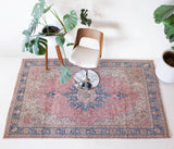 Vintage Turkish rug in living room setting, old rug, antique rug, pastel colors, faded colors, Turkish rug, vintage rug, soft rug, Portland, Oregon, rug store, rug shop, local shop