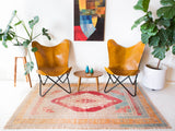 Area rug in a living room setting, pile rug, Turkish rug, old rug, antique rug, pastel colors, faded colors, Turkish rug, vintage rug, soft rug, Portland, Oregon, rug store, rug shop, local shop, distressed rug, worn out rug