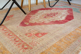 Area rug in a living room setting, pile rug, Turkish rug, old rug, antique rug, pastel colors, faded colors, Turkish rug, vintage rug, soft rug, Portland, Oregon, rug store, rug shop, local shop, distressed rug, worn out rug