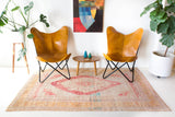 Area rug in a living room setting, pile rug, Turkish rug, old rug, antique rug, pastel colors, faded colors, Turkish rug, vintage rug, soft rug, Portland, Oregon, rug store, rug shop, local shop, distressed rug, worn out rug