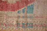 Area rug in a living room setting, pile rug, Turkish rug, old rug, antique rug, pastel colors, faded colors, Turkish rug, vintage rug, soft rug, Portland, Oregon, rug store, rug shop, local shop, distressed rug, worn out rug