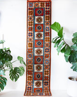 Vintage Turkish runner rug in a living room setting, pile rug, Turkish rug, vintage rug, portland, rug shop, bright colors, wild shaman, soft rug, bold color, Portland, Oregon, rug store, rug shop, local shop, antique rug