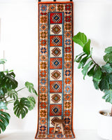 Vintage Turkish runner rug in a living room setting, pile rug, Turkish rug, vintage rug, portland, rug shop, bright colors, wild shaman, soft rug, bold color, Portland, Oregon, rug store, rug shop, local shop, antique rug