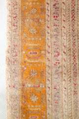 Area rug in a living room setting, pile rug, Turkish rug, old rug, antique rug, pastel colors, faded colors, Turkish rug, vintage rug, soft rug, Portland, Oregon, rug store, rug shop, local shop, distressed rug, worn out rug