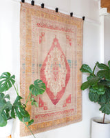 Area rug in a living room setting, pile rug, Turkish rug, old rug, antique rug, pastel colors, faded colors, Turkish rug, vintage rug, soft rug, Portland, Oregon, rug store, rug shop, local shop, distressed rug, worn out rug