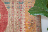 Area rug in a living room setting, pile rug, Turkish rug, old rug, antique rug, pastel colors, faded colors, Turkish rug, vintage rug, soft rug, Portland, Oregon, rug store, rug shop, local shop, distressed rug, worn out rug