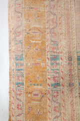 Area rug in a living room setting, pile rug, Turkish rug, old rug, antique rug, pastel colors, faded colors, Turkish rug, vintage rug, soft rug, Portland, Oregon, rug store, rug shop, local shop, distressed rug, worn out rug