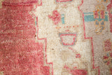 Area rug in a living room setting, pile rug, Turkish rug, old rug, antique rug, pastel colors, faded colors, Turkish rug, vintage rug, soft rug, Portland, Oregon, rug store, rug shop, local shop, distressed rug, worn out rug
