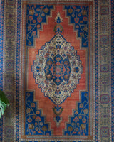 Vintage Turkish rug in a living room setting, pile rug, Turkish rug, vintage rug, portland, rug shop, bright colors, wild shaman, soft rug, bold color, Portland, Oregon, rug store, rug shop, local shop, antique rug