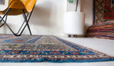 Vintage Turkish rug in a living room setting, pile rug, Turkish rug, vintage rug, portland, rug shop, bright colors, wild shaman, soft rug, bold color, Portland, Oregon, rug store, rug shop, local shop, antique rug