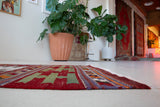 Vintage Turkish runner rug in a living room setting, pile rug, Turkish rug, vintage rug, portland, rug shop, bright colors, wild shaman, soft rug, bold color, Portland, Oregon, rug store, rug shop, local shop, antique rug