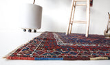 Vintage Persian rug in a living room setting, pile rug, Turkish rug, vintage rug, portland, rug shop, bright colors, wild shaman, soft rug, bold color, Portland, Oregon, rug store, rug shop, local shop, antique rug