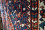 Vintage Persian rug in a living room setting, pile rug, Turkish rug, vintage rug, portland, rug shop, bright colors, wild shaman, soft rug, bold color, Portland, Oregon, rug store, rug shop, local shop, antique rug