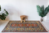 Vintage Turkish rug in a living room setting, pile rug, Turkish rug, vintage rug, portland, rug shop, bright colors, wild shaman, soft rug, bold color, Portland, Oregon, rug store, rug shop, local shop, antique rug,  sun colors, warm colors