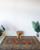 Vintage Turkish rug in a living room setting, pile rug, Turkish rug, vintage rug, portland, rug shop, bright colors, wild shaman, soft rug, bold color, Portland, Oregon, rug store, rug shop, local shop, antique rug,  sun colors, warm colors