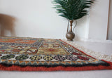 Vintage Turkish rug in a living room setting, pile rug, Turkish rug, vintage rug, portland, rug shop, bright colors, wild shaman, soft rug, bold color, Portland, Oregon, rug store, rug shop, local shop, antique rug,  sun colors, warm colors
