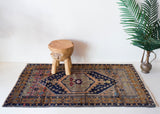 Vintage Turkish rug in living room setting, old rug, antique rug, pastel colors, faded colors, Turkish rug, vintage rug, soft rug, Portland, Oregon, rug store, rug shop, local shop