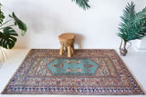Small area rug in a living room setting, pile rug, Turkish rug, old rug, antique rug, pastel colors, faded colors, Turkish rug, vintage rug, soft rug, Portland, Oregon, rug store, rug shop, local shop, cool colors