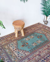 Small area rug in a living room setting, pile rug, Turkish rug, old rug, antique rug, pastel colors, faded colors, Turkish rug, vintage rug, soft rug, Portland, Oregon, rug store, rug shop, local shop, cool colors