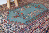 Small area rug in a living room setting, pile rug, Turkish rug, old rug, antique rug, pastel colors, faded colors, Turkish rug, vintage rug, soft rug, Portland, Oregon, rug store, rug shop, local shop, cool colors