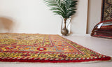Vintage Turkish rug in a living room setting, pile rug, Turkish rug, vintage rug, portland, rug shop, bright colors, wild shaman, soft rug, bold color, Portland, Oregon, rug store, rug shop, local shop, antique rug, floral rug