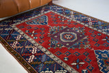 Vintage Turkish rug in a living room setting, pile rug, Turkish rug, vintage rug, portland, rug shop, bright colors, wild shaman, soft rug, bold color, Portland, Oregon, rug store, rug shop, local shop, antique rug,