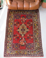 Vintage Turkish rug in a living room setting, pile rug, Turkish rug, vintage rug, portland, rug shop, bright colors, wild shaman, soft rug, bold color, Portland, Oregon, rug store, rug shop, local shop, antique rug,