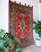 Vintage Turkish rug in a living room setting, pile rug, Turkish rug, vintage rug, portland, rug shop, bright colors, wild shaman, soft rug, bold color, Portland, Oregon, rug store, rug shop, local shop, antique rug,