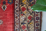 Vintage Turkish rug in a living room setting, pile rug, Turkish rug, vintage rug, portland, rug shop, bright colors, wild shaman, soft rug, bold color, Portland, Oregon, rug store, rug shop, local shop, antique rug,
