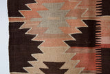 Vintage kilim rug in living room setting, old rug, antique rug, pastel colors, faded colors, Turkish rug, vintage rug, soft rug, Portland, Oregon, rug store, rug shop, local shop, earthy tones, earthy colors, warm colors