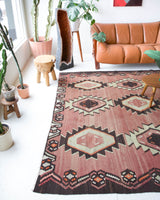 Vintage kilim rug in living room setting, old rug, antique rug, pastel colors, faded colors, Turkish rug, vintage rug, soft rug, Portland, Oregon, rug store, rug shop, local shop, earthy tones, earthy colors